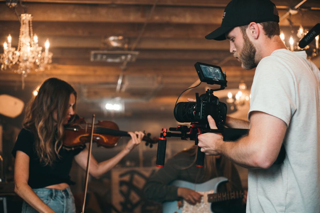 pexels-photo-2510425 A filmmaker capturing a violinist on set, highlighting video production.